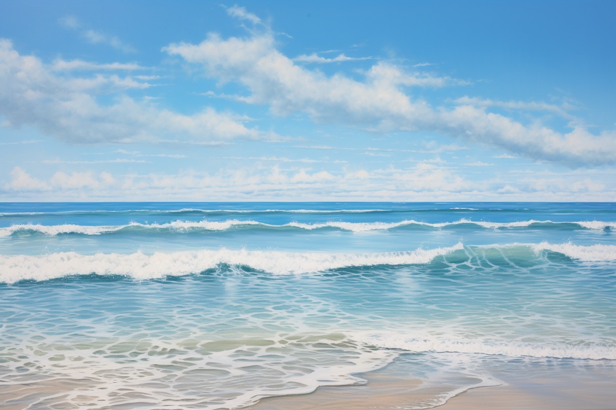 A panoramic view of a pristine ocean with gentle waves lapping the shore